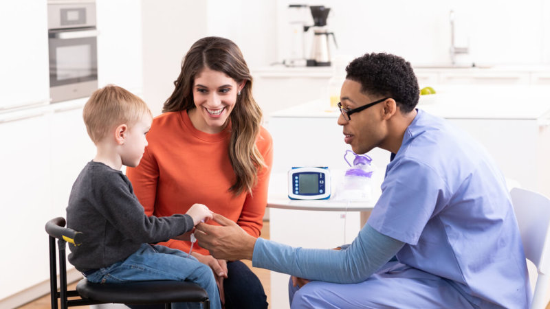 A woman, a child, and a doctor talking